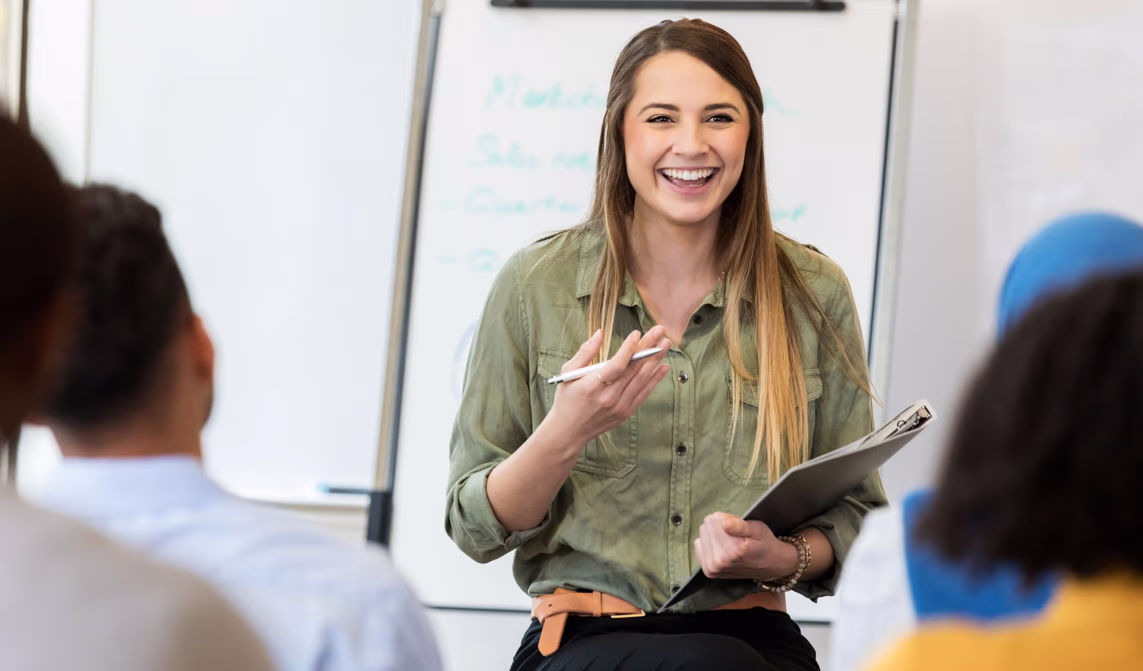 A leader smiling as she talks with her team